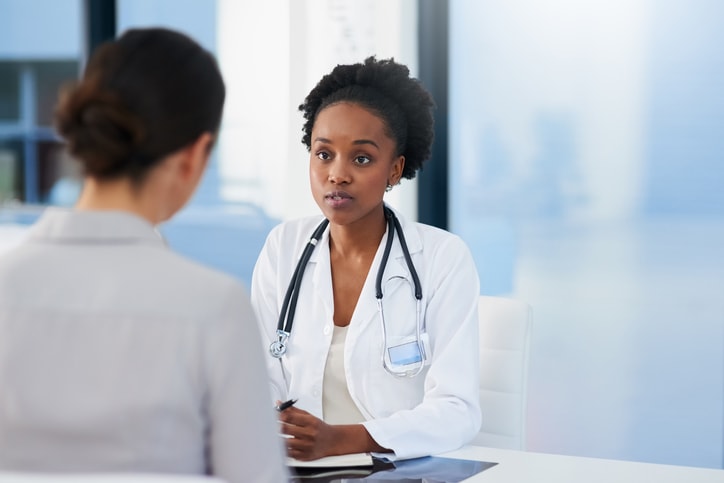 woman physician with female patient